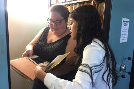 Amanda learning about documents used to create exhibitions and serve as learning tools for the public. Courtesy of the Museo de Historia, Antropología y Arte.