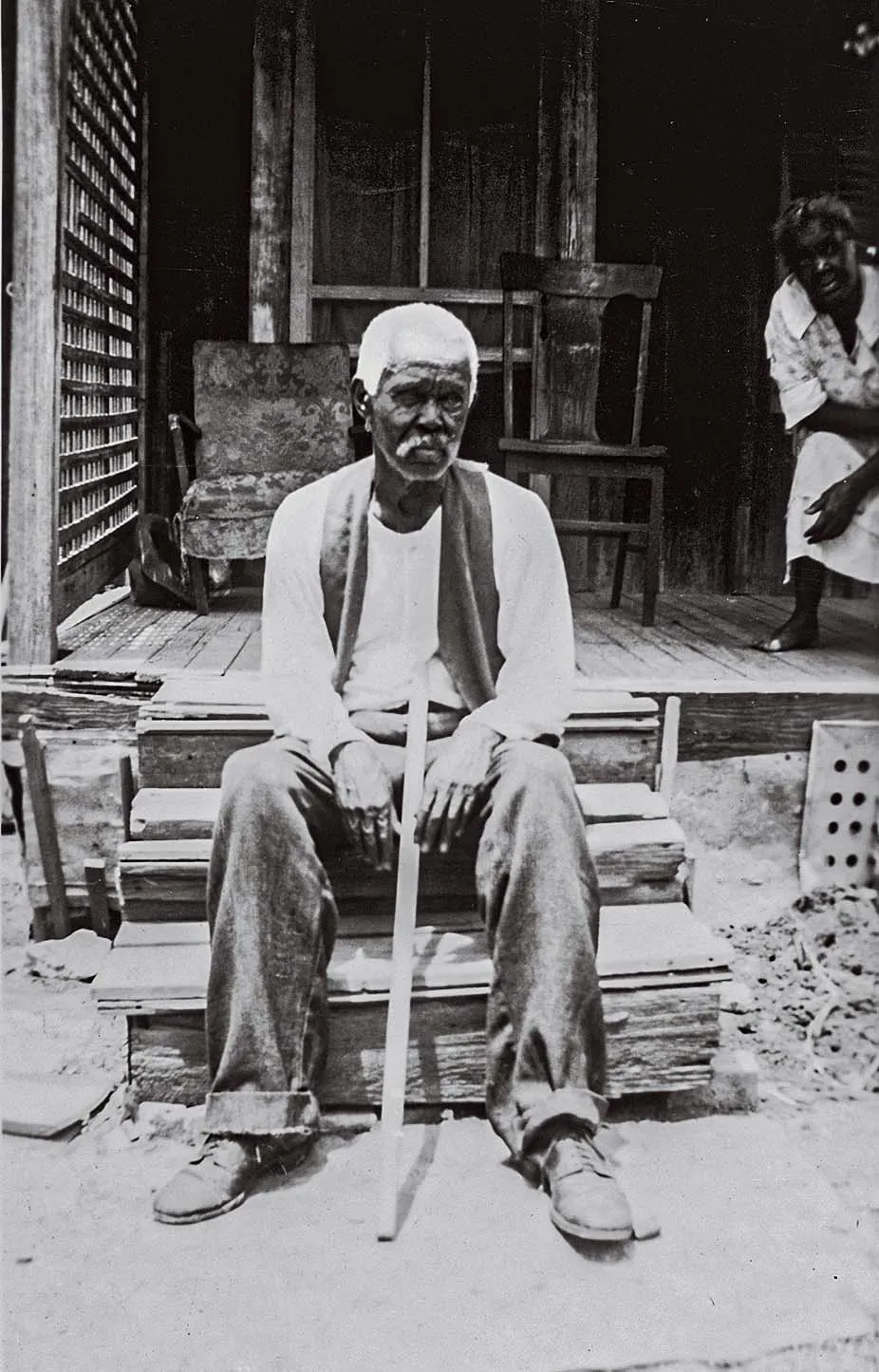 a man sits on steps for a portrait