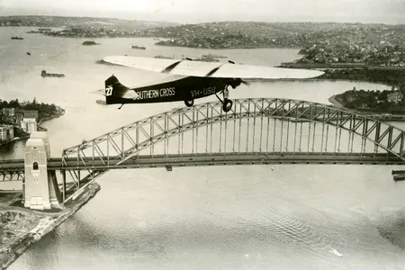 After his celebrated trans-Pacific flight, Charles Kingsford Smith flies the famed Southern Cross over Sydney Harbor.