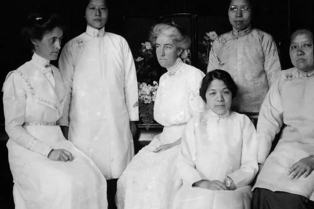 Tien Fuh Wu (standing in the back, on the left) and Donaldina Cameron (seated, center) with a group of women who may have been Mission Home staffers. _ Courtesy of Louis B. Stellman, California State Library..png