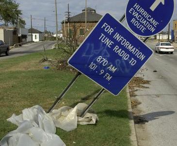 Sign marking an evacuation route, tilted by the storm. Photograph by Hugh Talman.