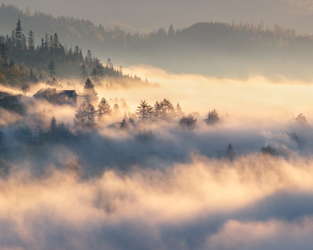 A wave of clouds flowing over the village.