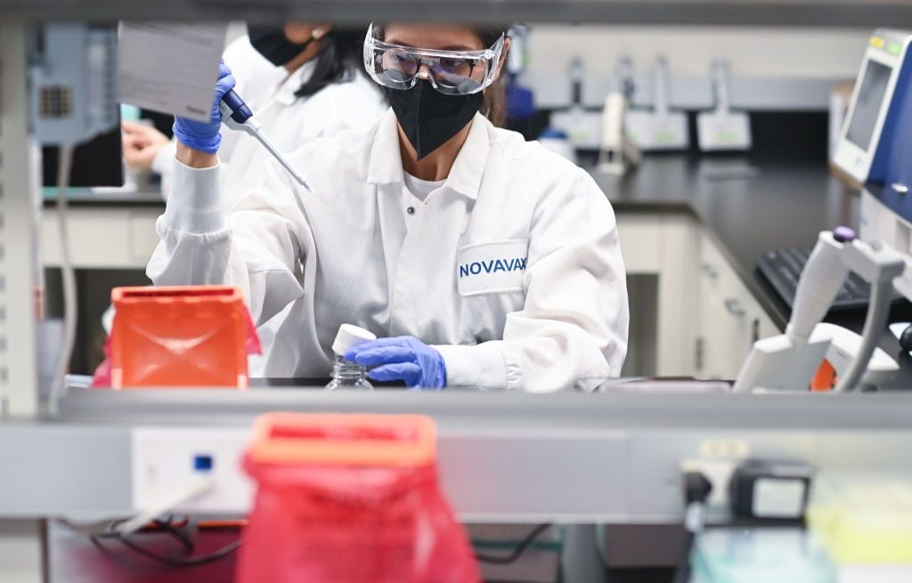 An image of a woman working in a Novavax laboratory