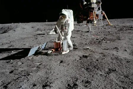 Apollo 11 astronaut Buzz Aldrin deploys a device to detect moonquakes during the first moonwalk.