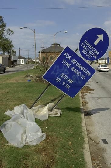 Blue road sign knocked askew