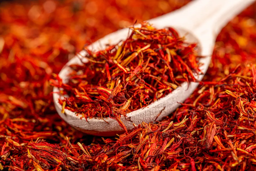 Pile of saffron with wooden spoon