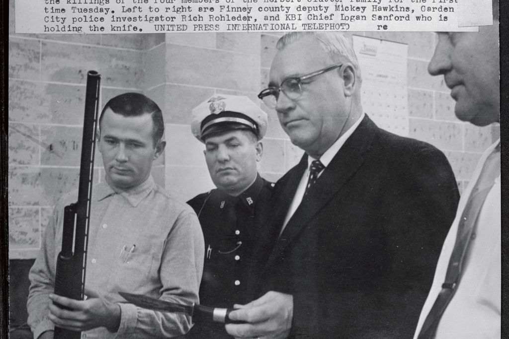 Officers display shotgun and knife used in the killings of the four members of the Herbert Clutter family