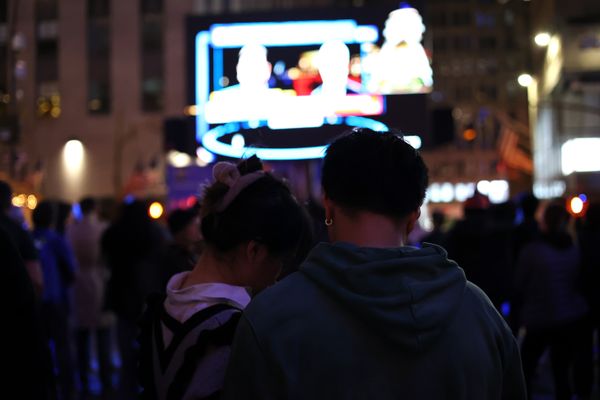 A young couple watch the election results at Rockefeller Center thumbnail