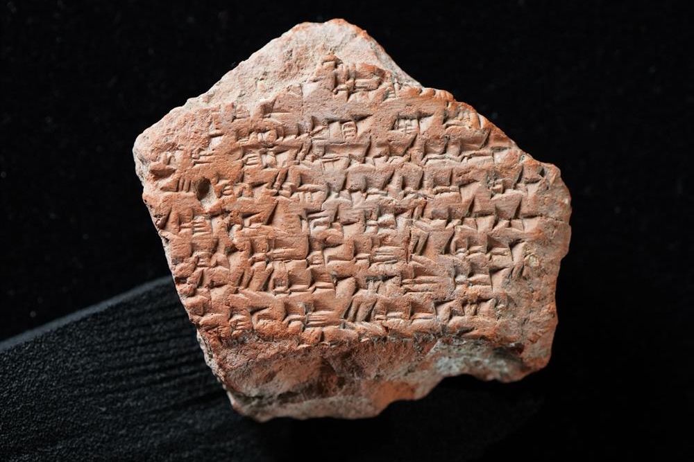 The piece of a clay tablet is marked with Akkadian cuneiform, and its text belongs to the Kadesh Peace Treaty, created by ancient Egyptians and Hittites in the 