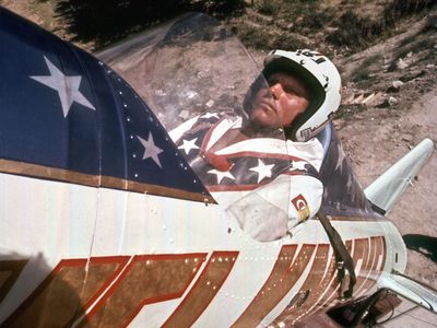 Evel Kneivel shown here in this promotional still from the 2015 documentary Being Evel, about to launch in the Skycycle X-2, a steam-powered rocket, wearing a helmet, of course. 
