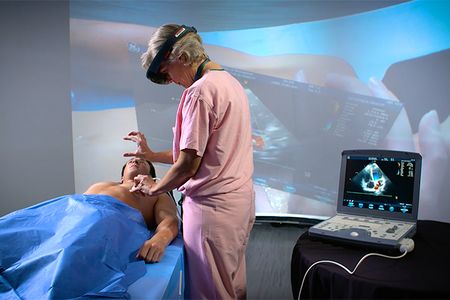 Trauma surgeon Sarah Murthi tests an AR headset prototype, which uses a Microsoft HoloLens and custom software with an ultrasound, on a volunteer "patient."