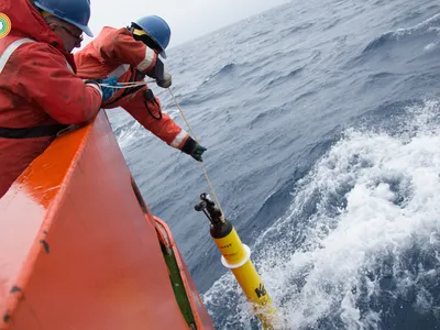An autonomous float is lowered into the waters of Southern Ocean. Part of the SOCCOM project, floats like this measure a variety of parameters that allow scientists to determine whether the waters are absorbing or releasing carbon dioxide.
