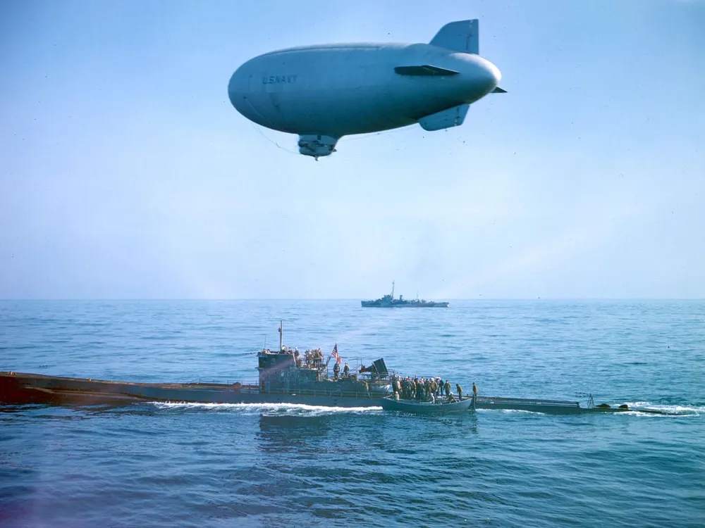 A US flag flies over the captured U-858 as it receives a K-ship escort to Lewes, Delaware. (Official US Navy photograph via National Archives and Records Administration.)