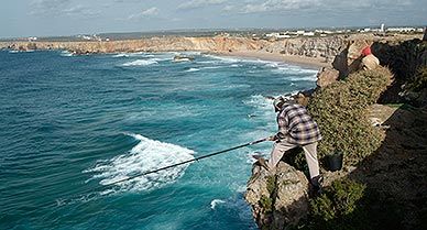 Fisherman casts off from the cliffs of Cape Sagres.