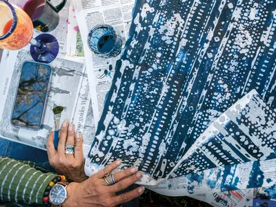 Artist Arianne King Comer works with indigo ink and rice paper at a farm on Wadmalaw Island, South Carolina.