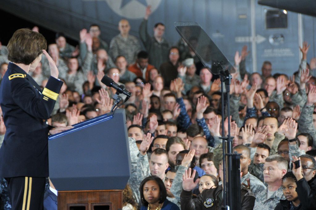 Army Reserve members raise hands