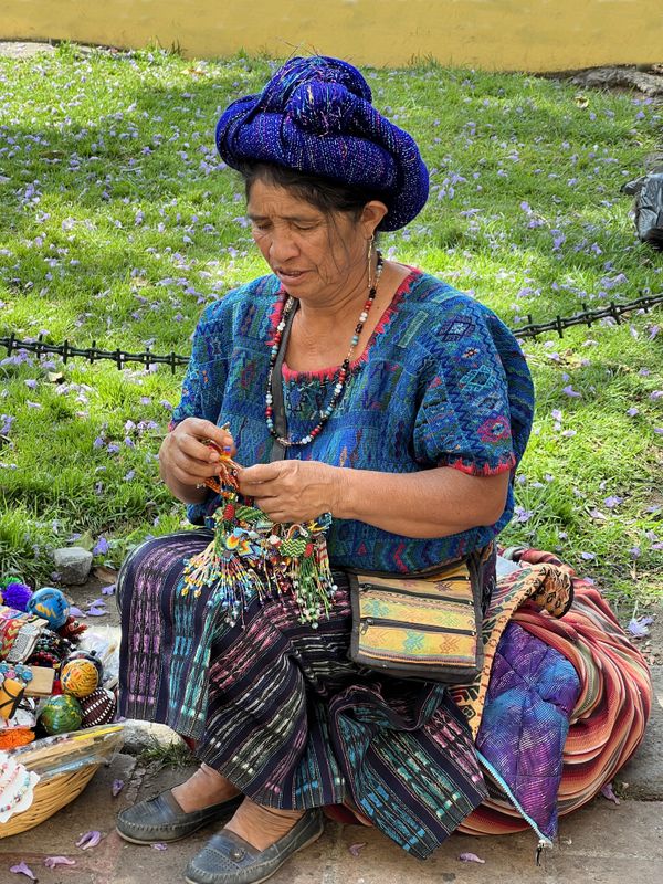 Women In Antigua, Guatemala, making trinkets for sale. thumbnail