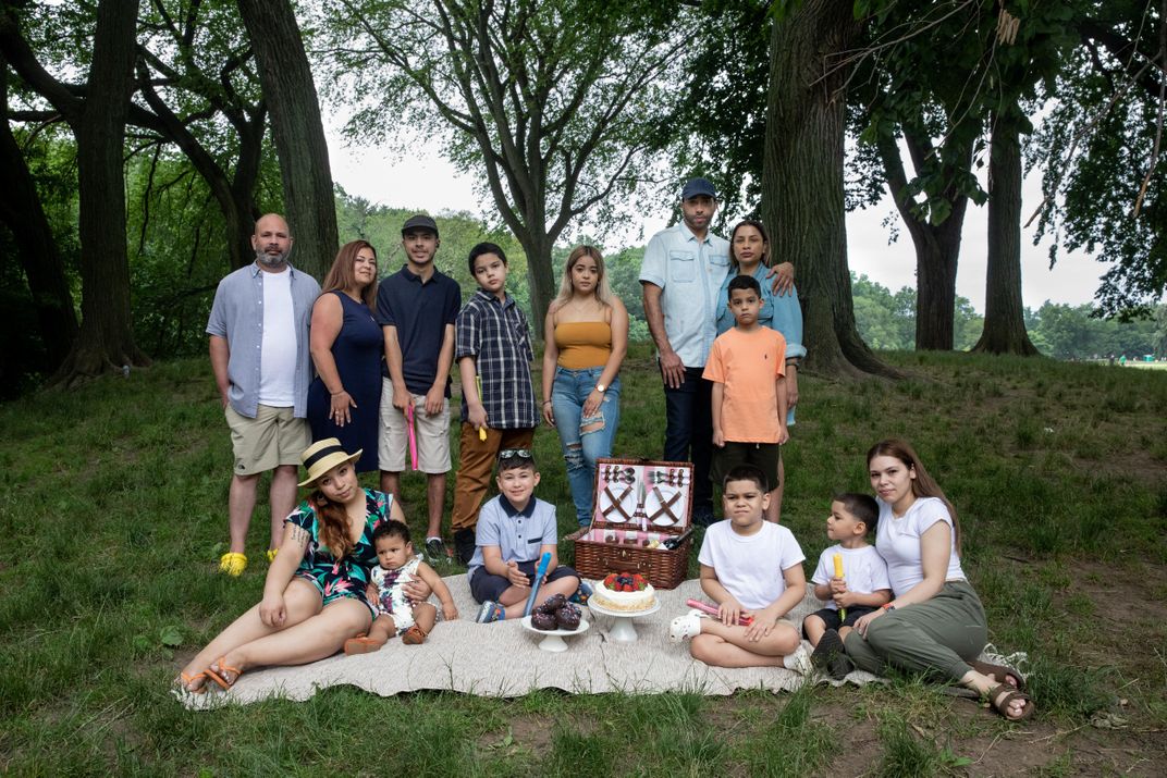 A family portrait in a park, including several young children