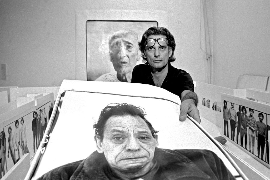 Photographer Richard Avedon holding photograph in his New York City studio in 1975