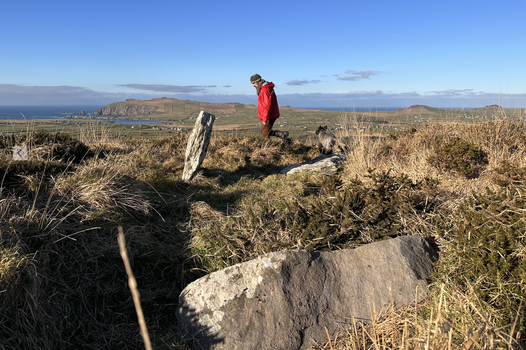 Man in a red jacket on a hilltop