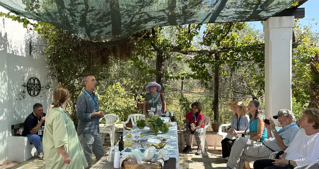 Travelers attending an olive oil demonstration. Credit: Andrew Becker