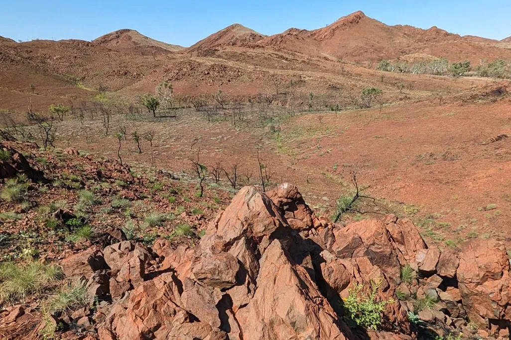 Brown dry landscape with cones of broken rock in the foreground