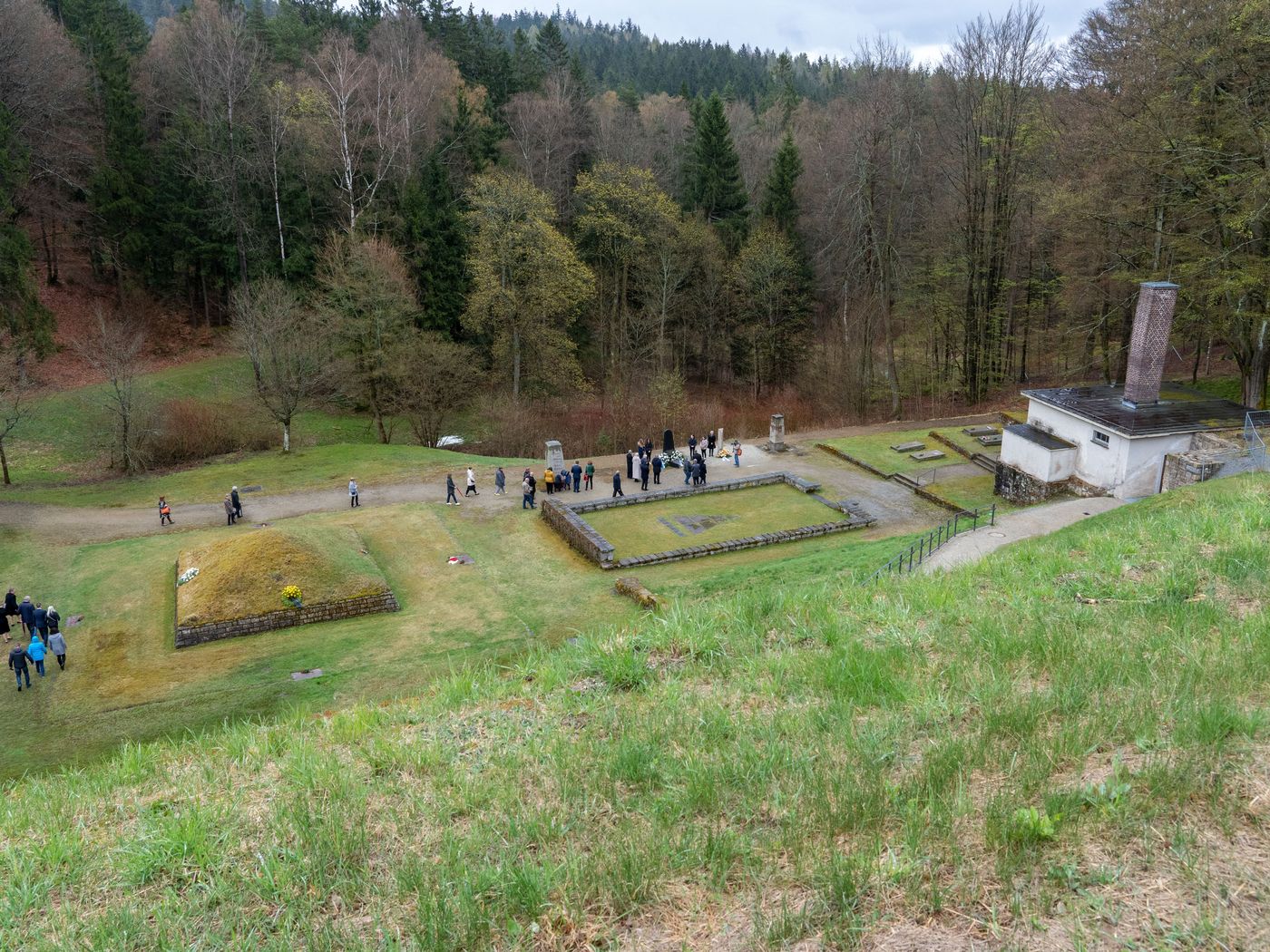 Visitors lay wreaths at the “Square of Nations,” a memorial site at the former Flossenbürg concentration camp’s crematorium, on April 24, 2022.