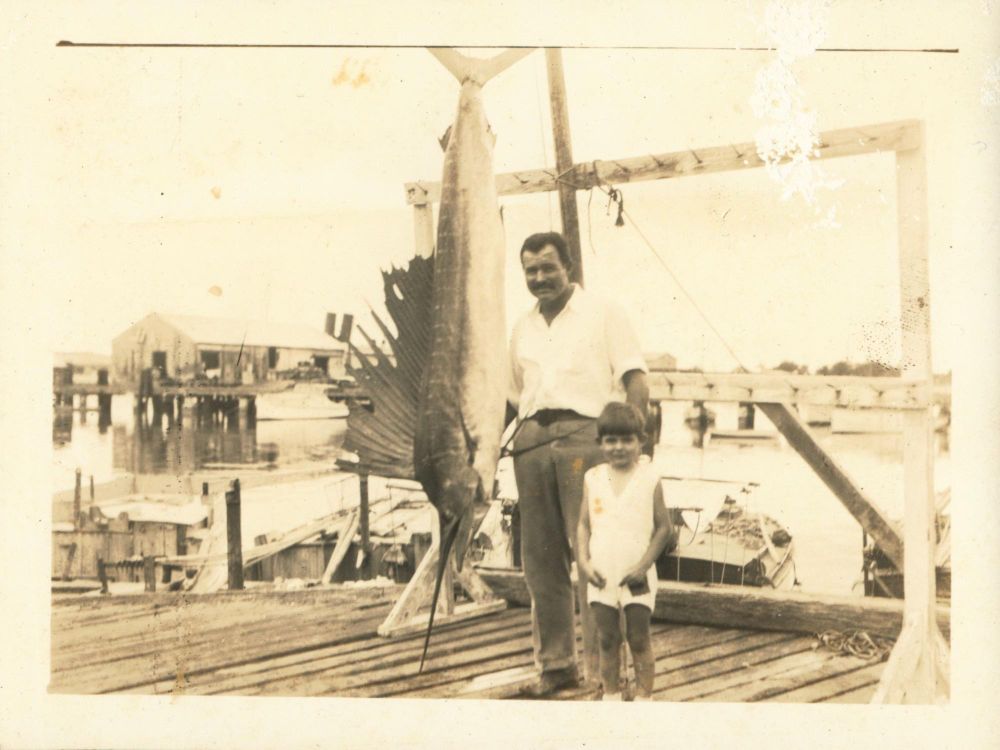 Ernest Hemingway and his middle son, Patrick, pose with a record 119.5-pound Atlantic sailfish caught off Key West, Florida, in May 1934.