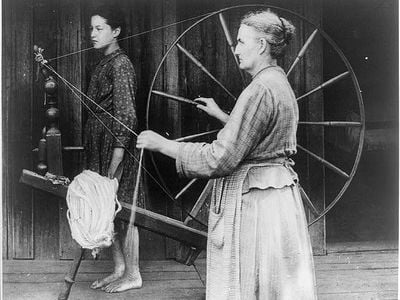 An unknown woman spinning, circa 1900.