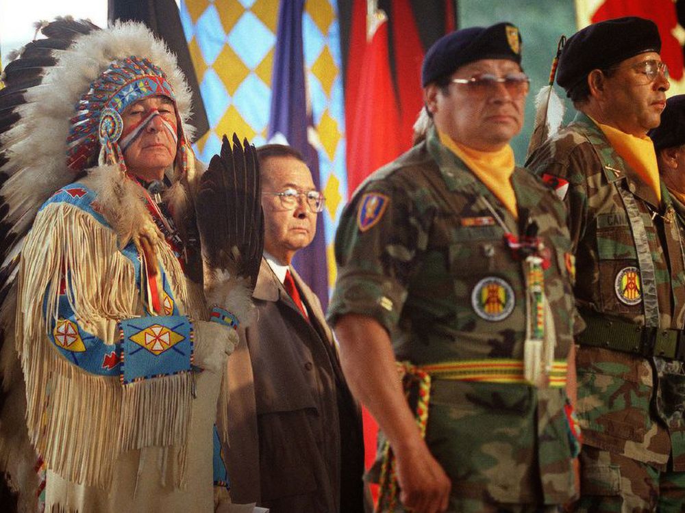 Dressed in ceremonial regalia, Senator Ben Nighthorse Campbell (Northern Cheyenne), a veteran of the Korean War, stands with World War II veteran Senator Daniel K. Inouye  and Native American veterans  of the Vietnam War during the opening of the National Museum of the American Indian on the National Mall.  September 21, 2004, Washington, D.C. (Mario Tama/ AFP for the National Museum of the American Indian, Smithsonian)