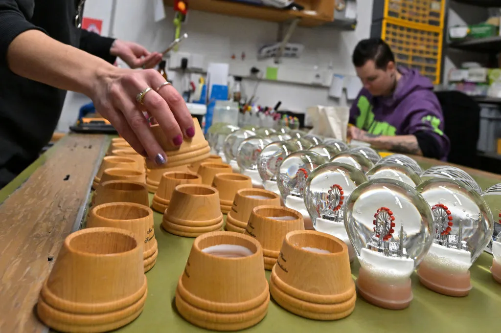workers assembling snow globes at Original Vienna Snow Globe Factory