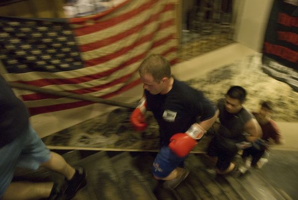 White collar workers work out in a boxing gym beside wall street. thumbnail
