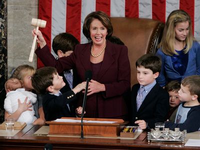 Newly elected Speaker of the House Nancy Pelosi, surrounded by children and grandchildren of members of Congress, holds up her gavel in the U.S. Capitol on Thursday, Jan. 4, 2007.