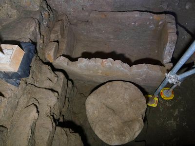 A 55-inch wide sarcophagus and what appears to be an altar are seen in an underground chamber at the ancient Roman Forum.