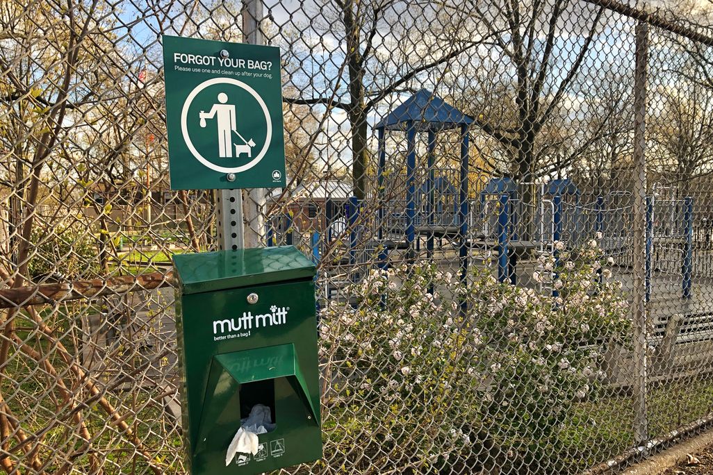 A container with dog waste pick up bags outside a park in New York City.