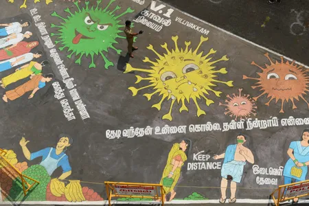 A policeman stands over a graffiti drawn to bring awareness to social distancing as a preventive measure against COVID-19 in Chennai, India, on April 9, 2020