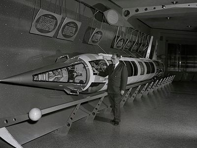 Willy Ley with a Viking sounding rocket on display at the American Museum of Natural History in New York, 1956.