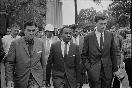 James Meredith, center, is escorted by federal marshals on his first day of class at the University of Mississippi.