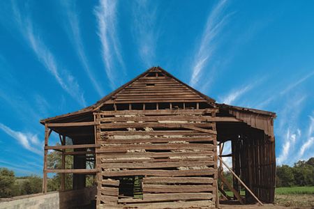 Artifact of bondage: This 19th-century tobacco barn (on its original site, a Kentucky alfalfa pasture, in 1998) contains an interior hut fitted with manacles. The entire structurea slave jailwas dismantled and moved to Cincinnati, Ohio, where it forms the centerpiece of the National Underground Railroad Freedom Center, which opened in August.