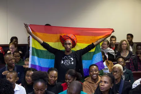 An activist holds up a rainbow flag inside Botswana's High Court to celebrate Tuesday's landmark ruling.