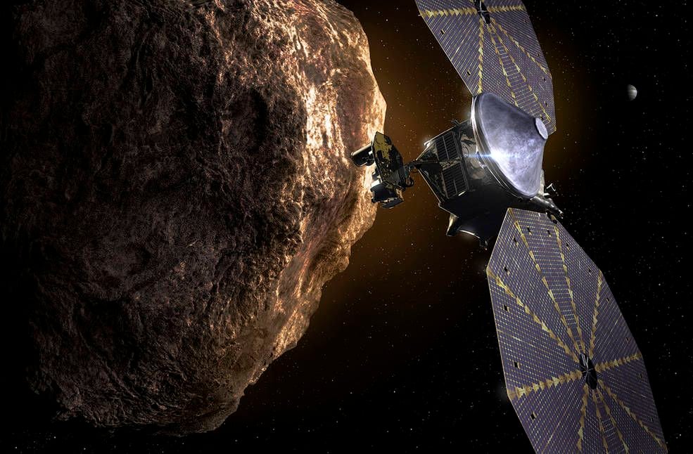 An artist rendering of NASA's Lucy space craft orbiting near one of the Trojan Asteroids