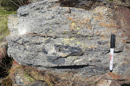 A rock layer showing the S2 impact tsunami bed with chunks of ripped-up seafloor