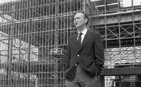 Michael Collins stands in front of the steel skeleton of the new National Air and Space Museum in July 1974