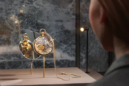 A visitor examines a watch&nbsp;crafted by&nbsp;Abraham-Louis Breguet&nbsp;for Marie Antoinette.