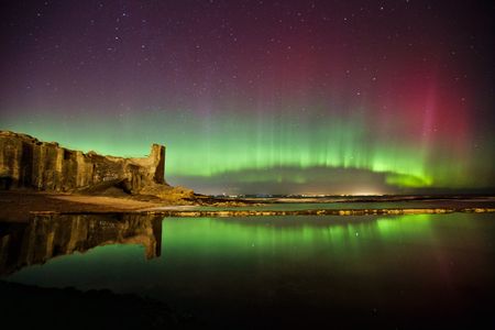 The northern lights glow over Castle Sands in Saint Andrews, Scotland at 10 P.M. Sunday, March 6, 2016. Captured by Aurorasaurus participant Alex Thompson 