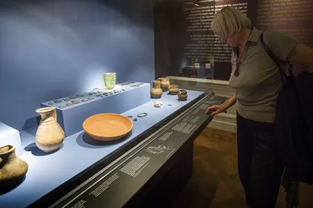 A visitor examines artifacts from the exhibition &quot;Crimea: Gold and Secrets of the Black Sea&quot; at the Allard Pierson Museum in Amsterdam in 2014.
