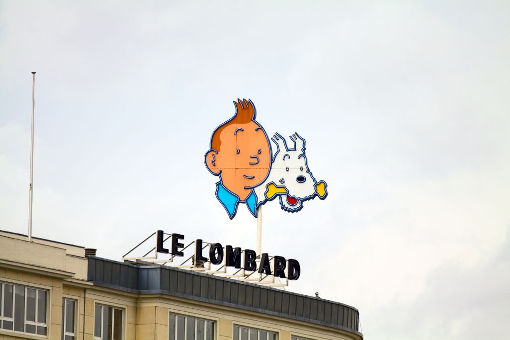 Billboard sign of young boy with orange hair and white dog