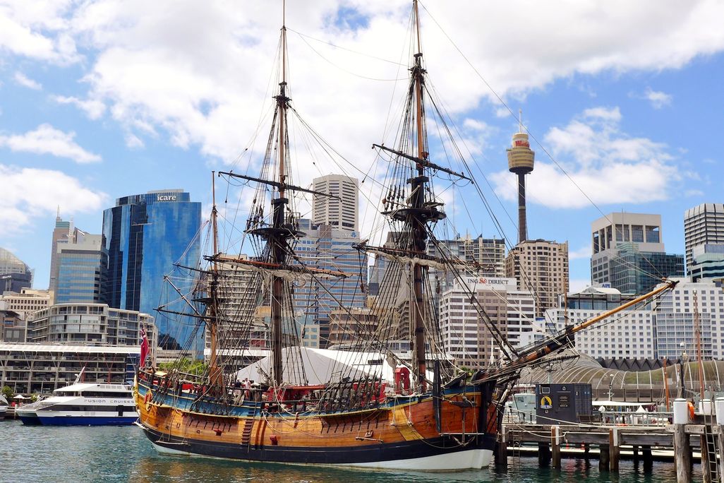 giant wooden three-mast ship parked in harbor at Sydney.