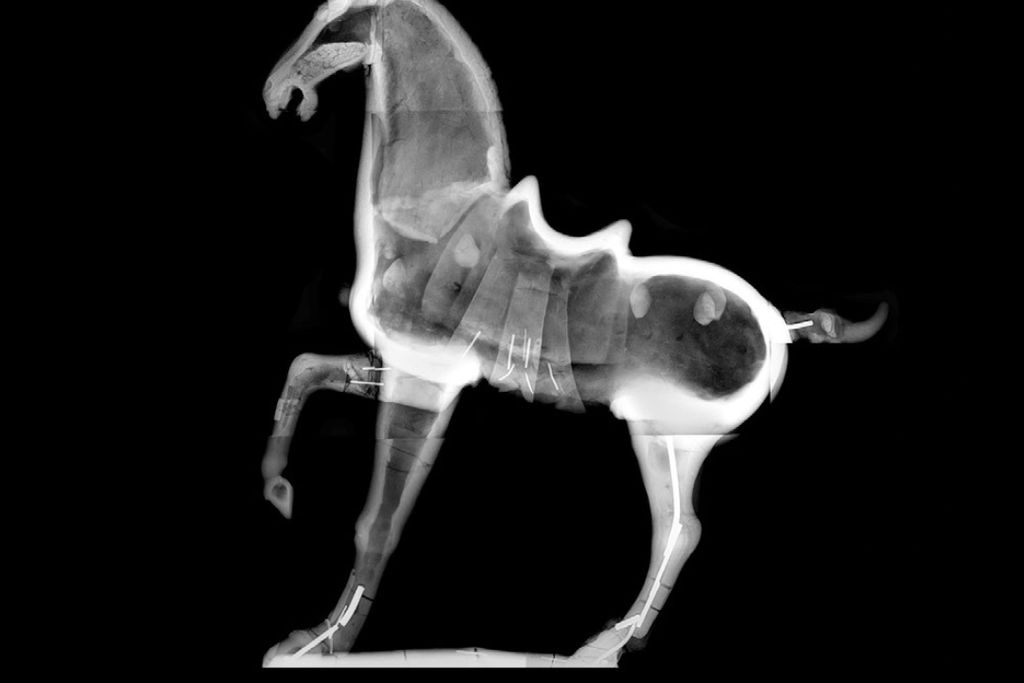 black and white horse sculpture with one foot raised