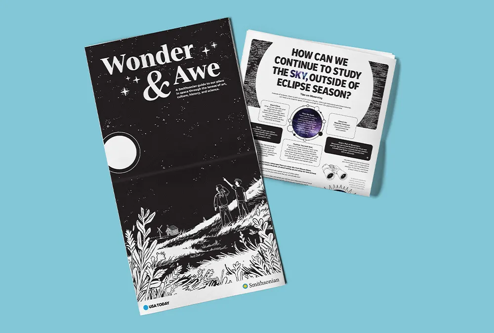 Light blue background with a newspaper extended featuring the words "Wonder & Awe" and a folded newspaper highlighting eclipse news